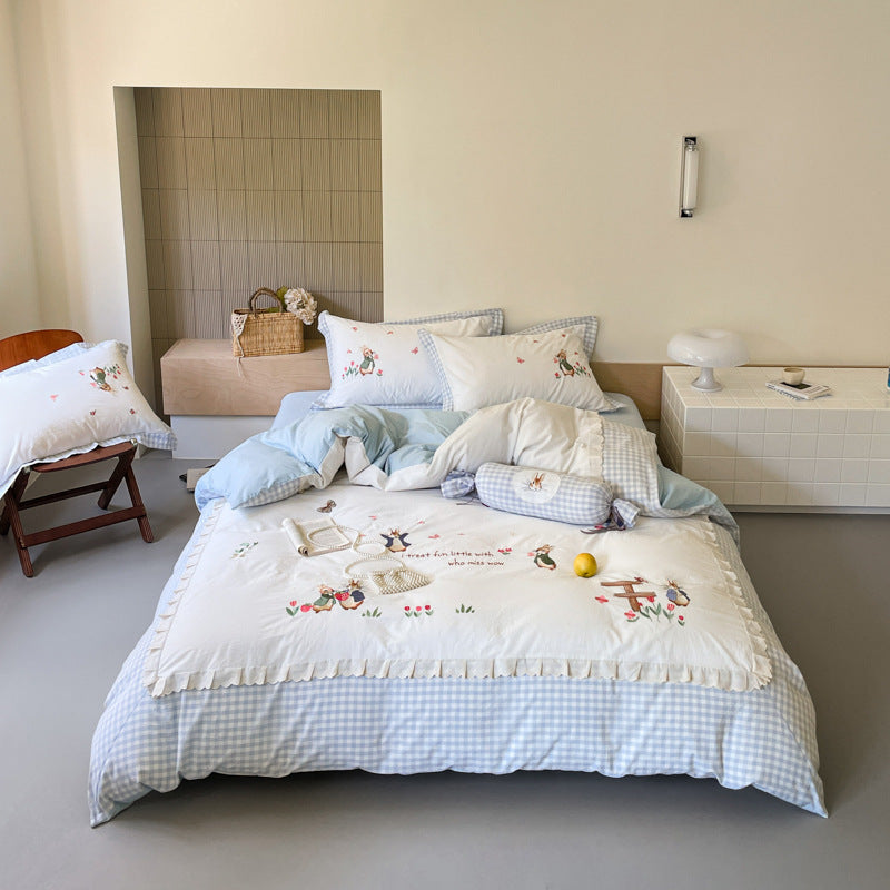 Romantic bedding set with embroidered rabbit motifs and delicate ruffles