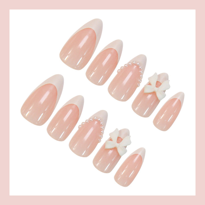 Acrylic nail set with elegant floral embellishments and trendy French tip Stornfield