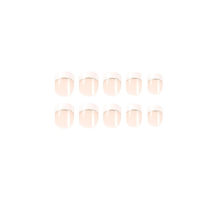 Artful nail extensions with elegant French tip and gold accents Stornfield