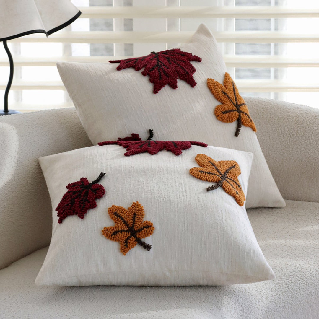 Decorative cushion with embroidered leaf design