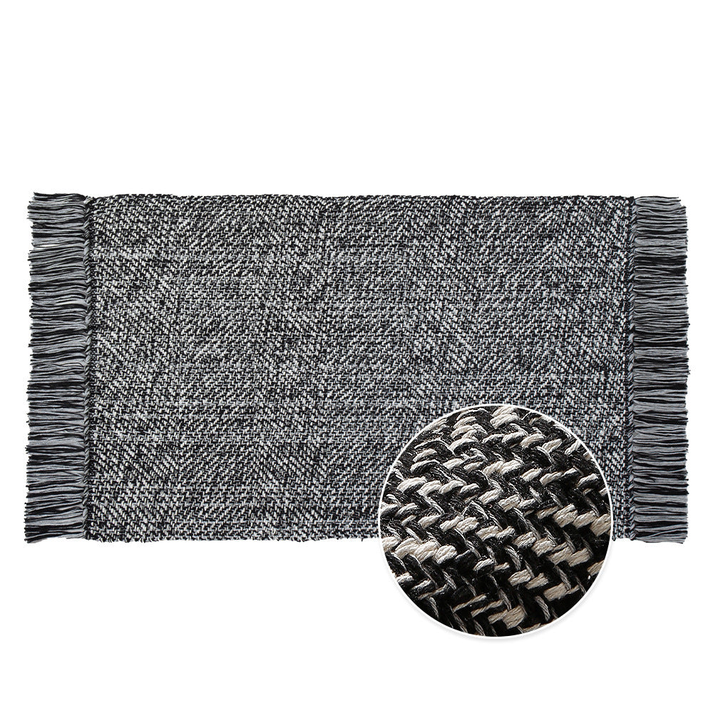 Handwoven table runner in herringbone pattern with decorative fringes
