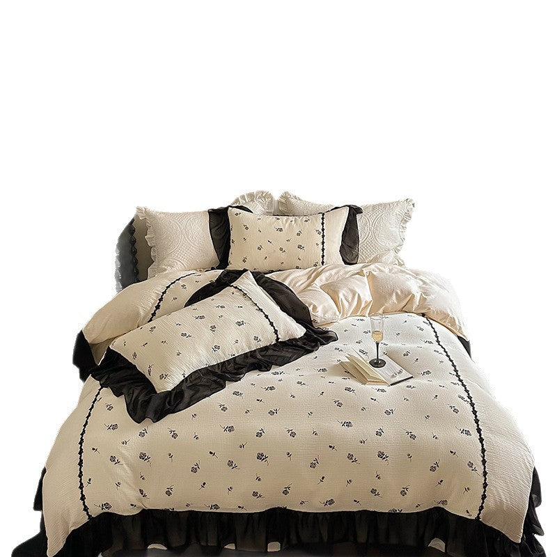 Country house bedding set with quilted bedspread, delicate rose print and ruffle trim