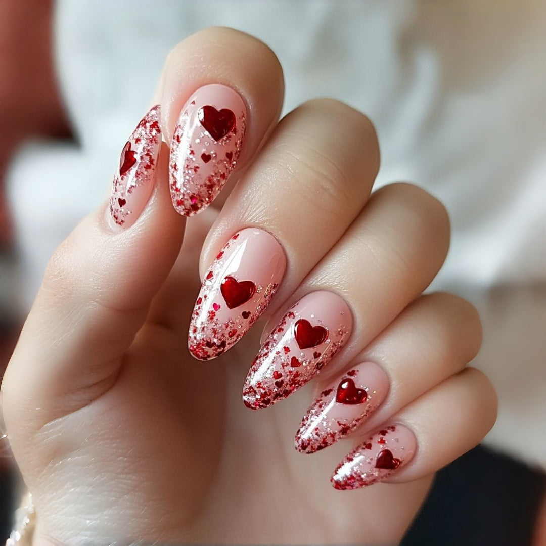 Artificial nails with sparkling heart design and glitter coating Stornfield