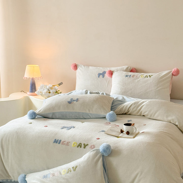 Cozy cotton bedding set with pom-pom appliques and embroidered lettering