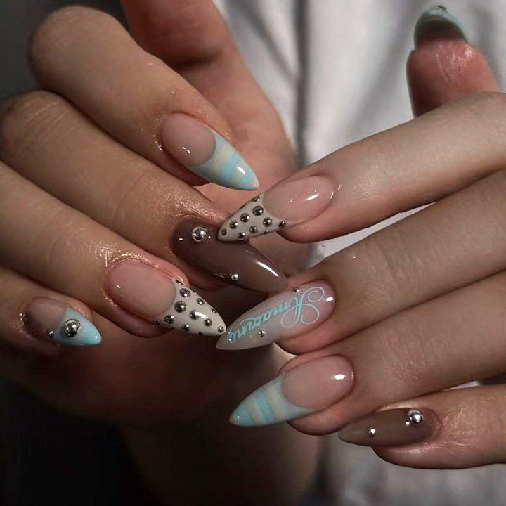 Artificial stiletto nails with glamorous applications Stornfield