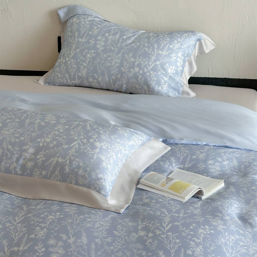 Luxurious satin bedding set with floral watercolor print, ruffled edges and reversible function