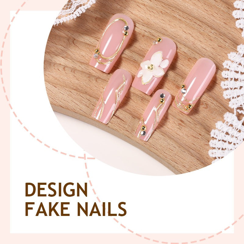 Elegant artificial nail set with decorative flower and gold embellishments Stornfield