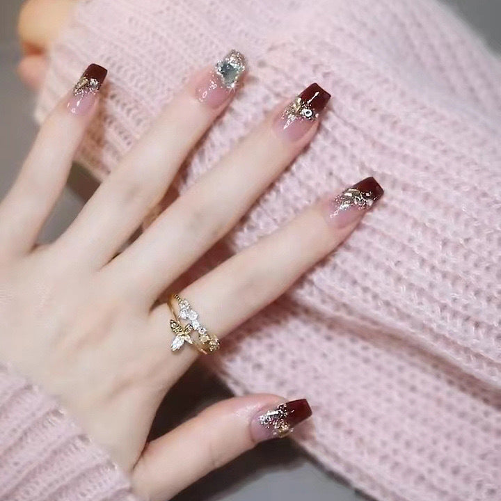 Artificials nails with glitter embellishments and elegant accents Stornfield