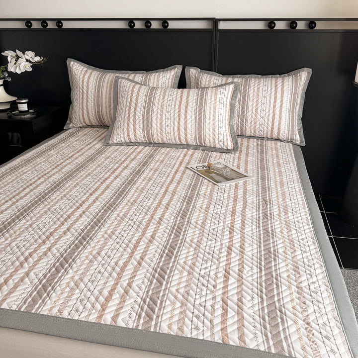 Quilted bedspread and pillow set with geometric striped quilting