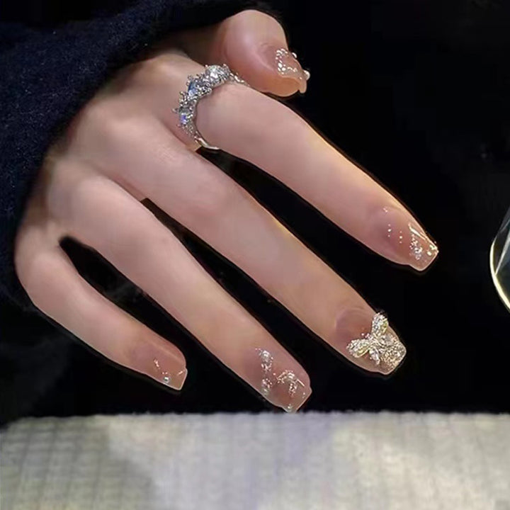 Artificial nails in an elegant design with 3D butterflies and glitter accents Stornfield