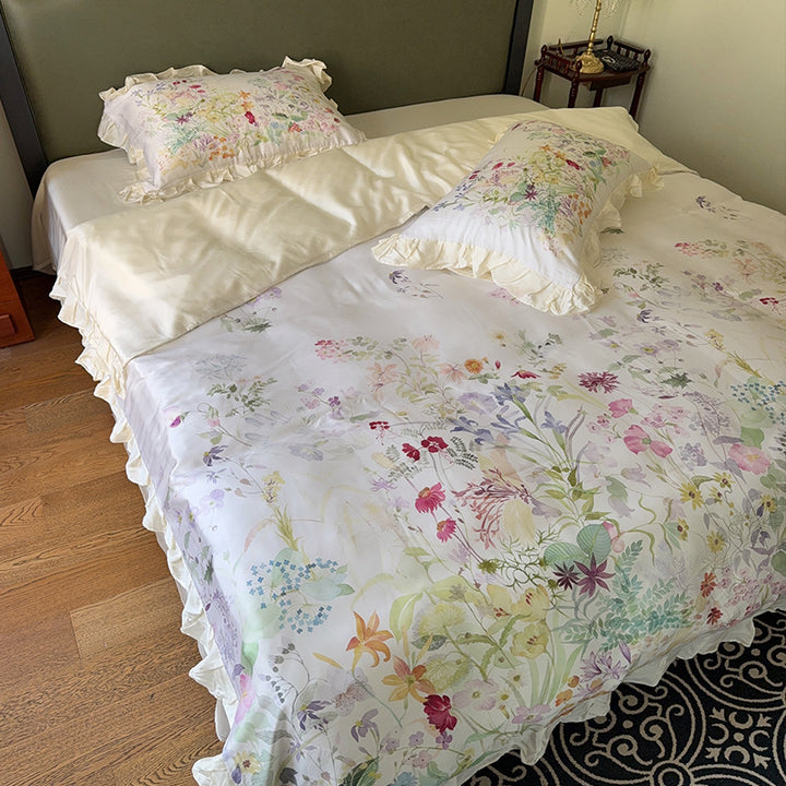 Cotton satin bed linen set with delicate watercolor botanical print and decorative ruffle