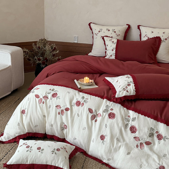 Bedding set with embroidered rose motif, ruffle and reversible feature