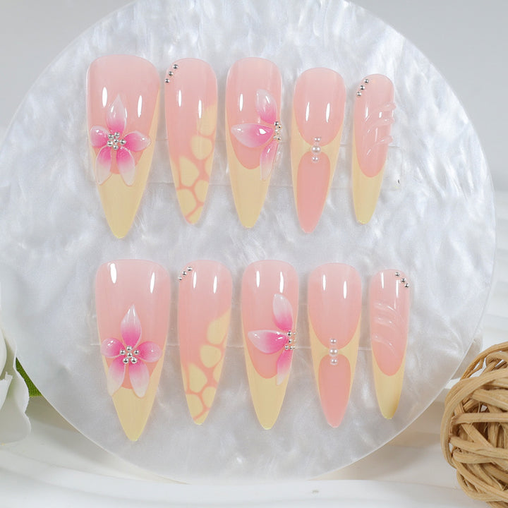 Acrylic nail set with elegant floral pattern and shimmering accents Stornfield
