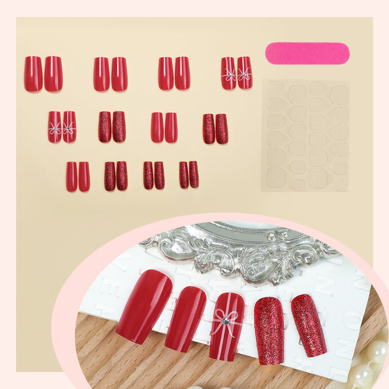 Creative acrylic nail set with glitter and bow designs Stornfield