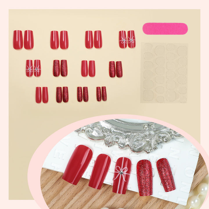 Creative acrylic nail set with glitter and bow designs Stornfield