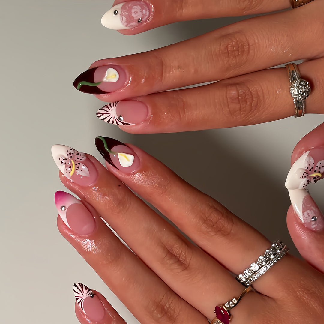 Artificial nails with creative floral designs and glitter accents Stornfield