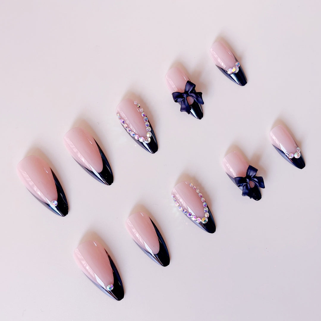Artificial nail set with glamorous 3D bows and rhinestone embellishments Stornfield