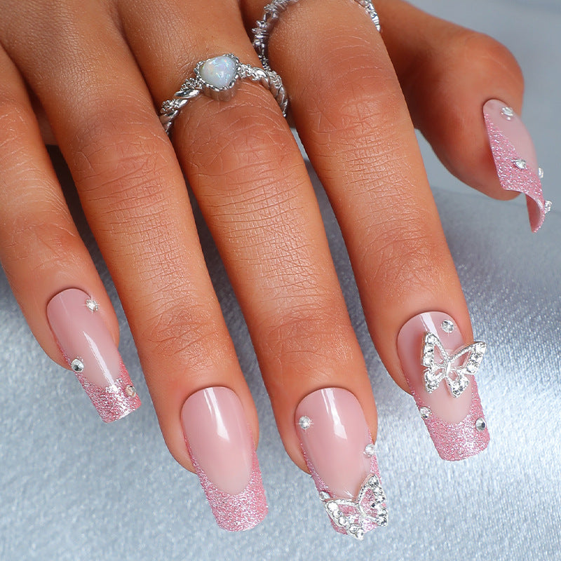 Acrylic nail set with sparkling glitter accents and elegant butterfly motifs Stornfield