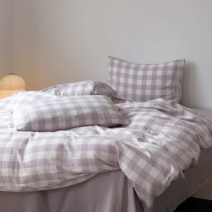 Duvet cover set made of lightweight cotton muslin featuring a checked texture and decorative embroidery design