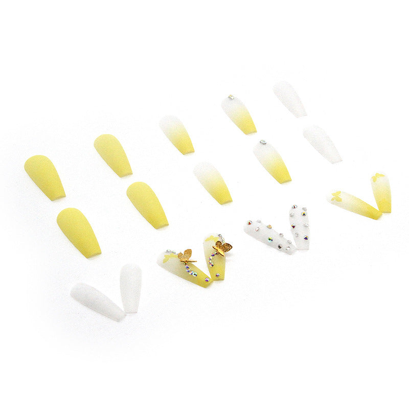 Artificial nail extensions with floral accents and rhinestones Stornfield