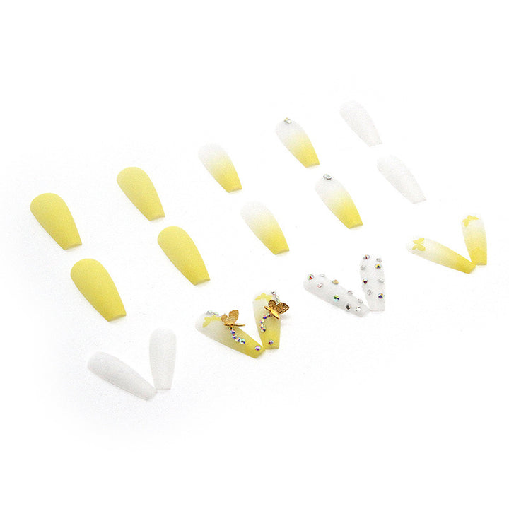 Artificial nail extensions with floral accents and rhinestones Stornfield