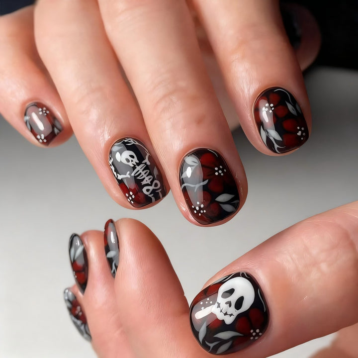 Creative nail art with skull motif and floral elements Stornfield