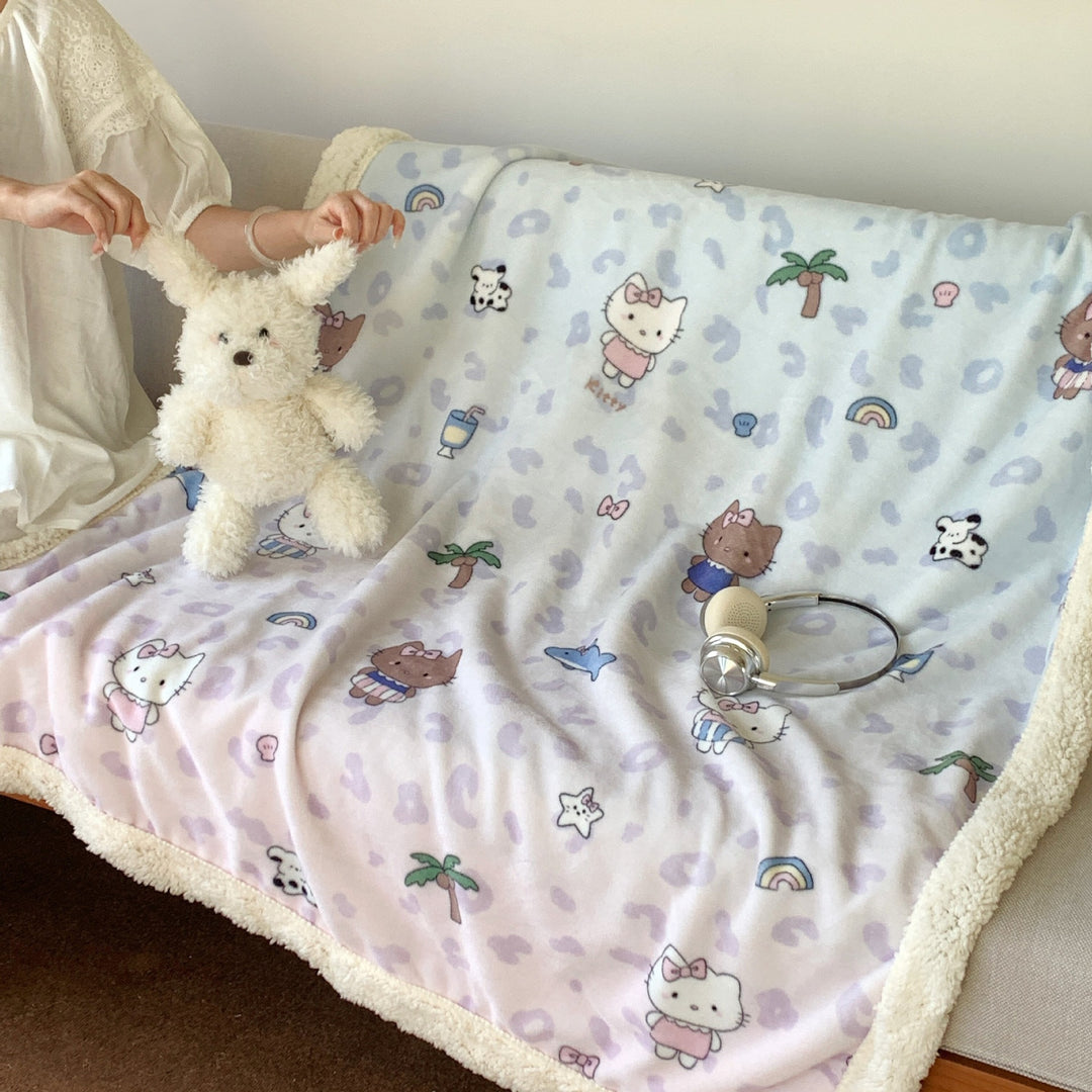 Reversible fleece blanket with cartoon cat design and teddy lining