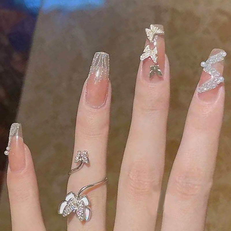 Artificial nails with sparkling rhinestone and bow accents Stornfield