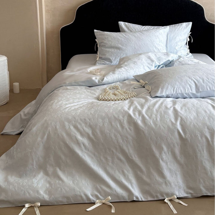 Luxurious cotton satin bed set with delicate ribbon ties and jacquard relief