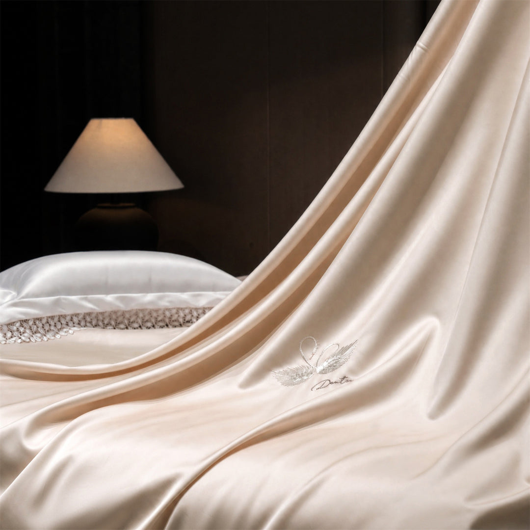 Luxurious satin bedding set with embroidered swan motif and lace pillow