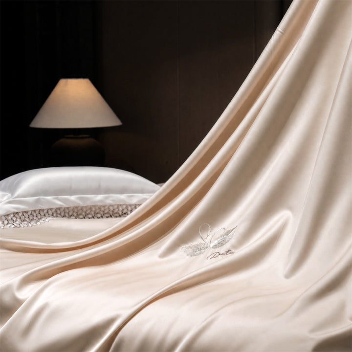 Luxurious satin bedding set with embroidered swan motif and lace pillow
