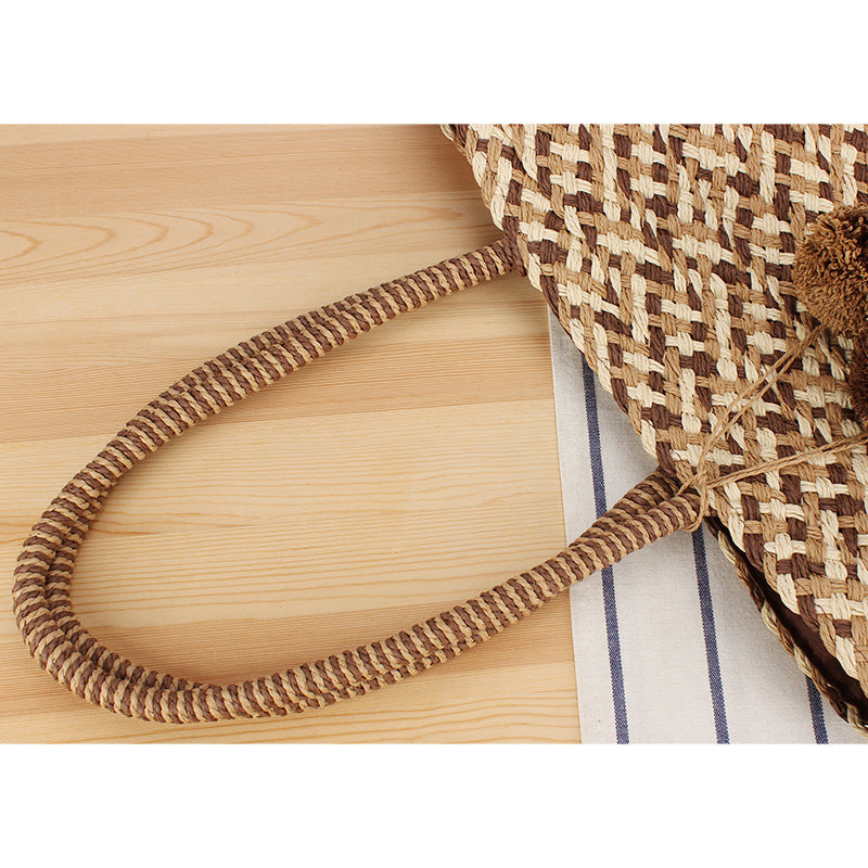Summer wicker handbag with pom poms Stornfield