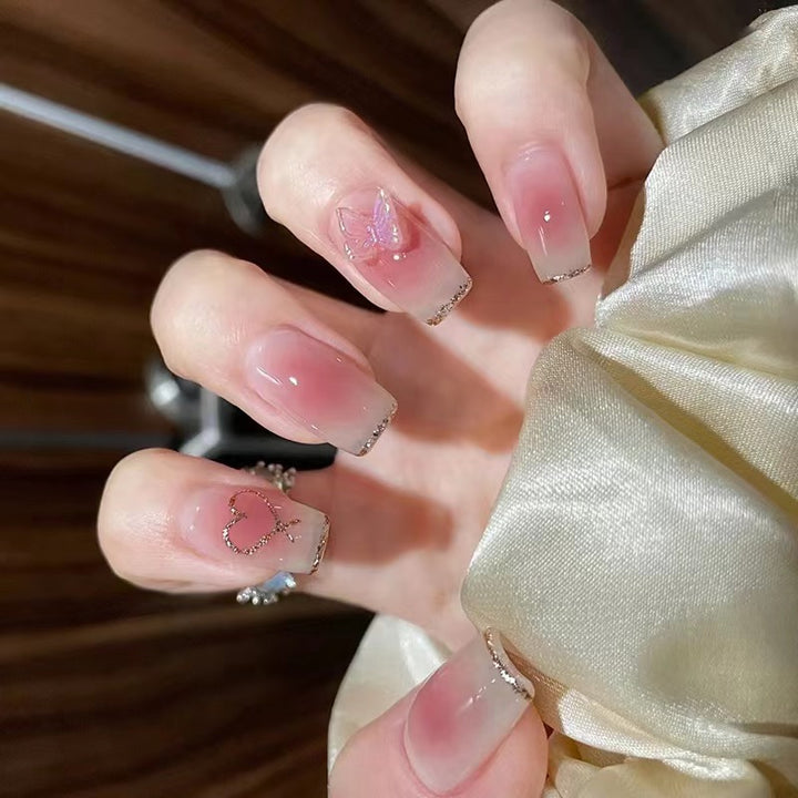 Artistic acrylic nails with heart and butterfly motifs Stornfield