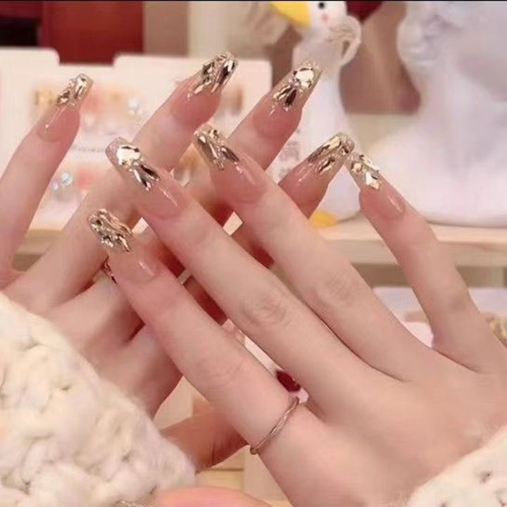 Glamorous artificial nails with gold decoration