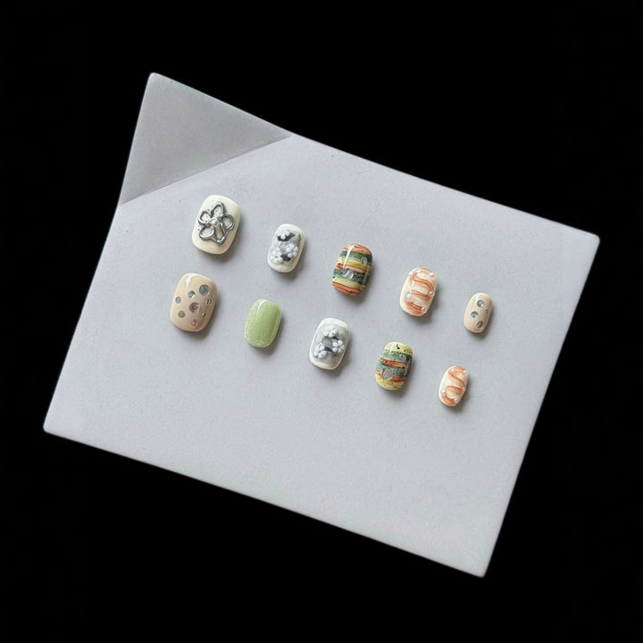 Artistic Press-On Nail Set with Floral and Textured Designs