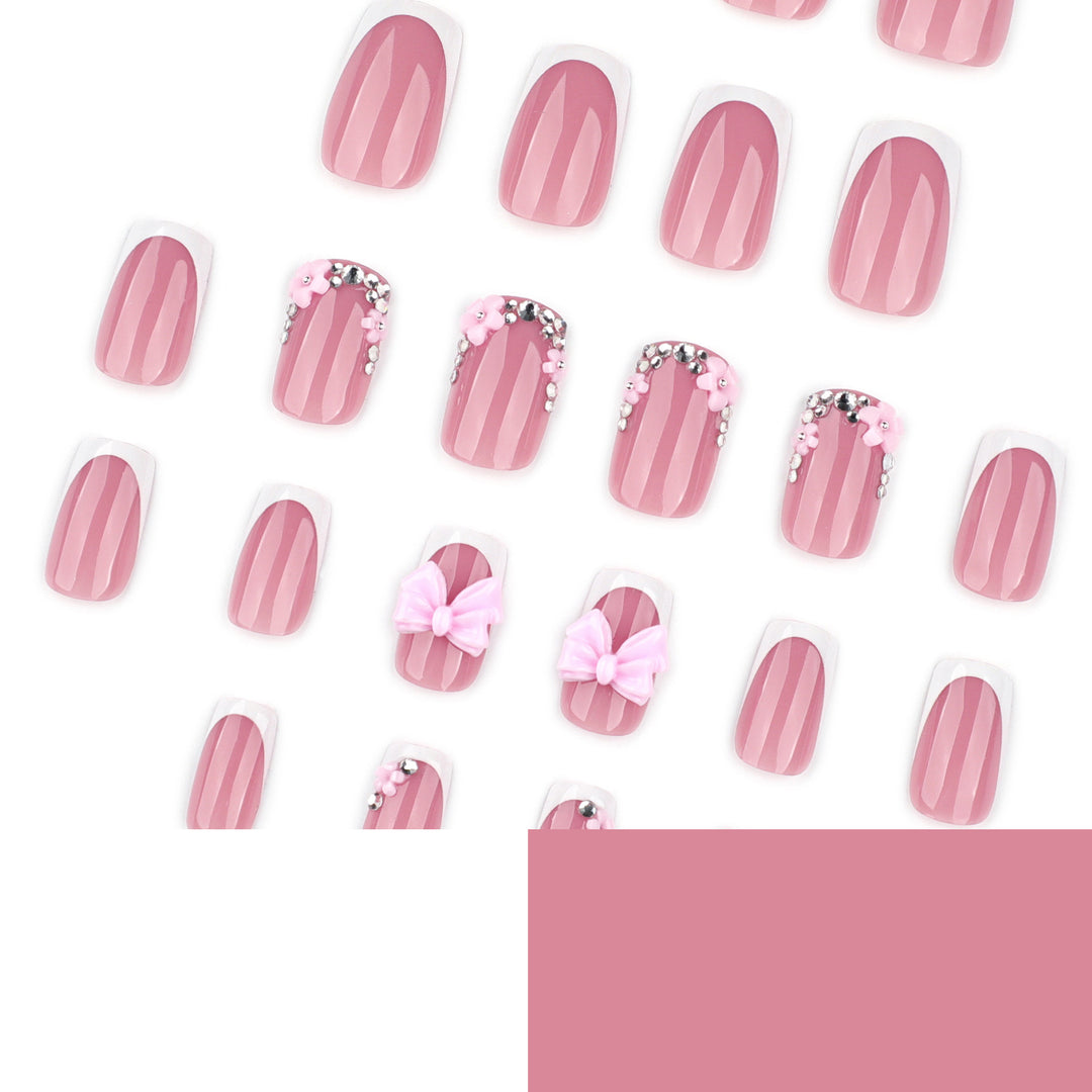 Artful nail extensions with sparkling accents and bow decorations Stornfield