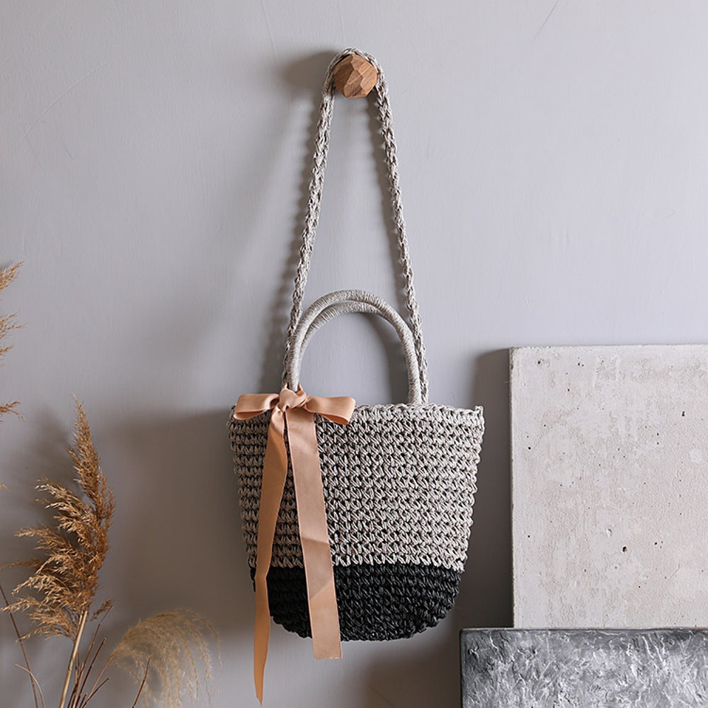 Basket bag with stylish carrying handles and decorative bow Stornfield