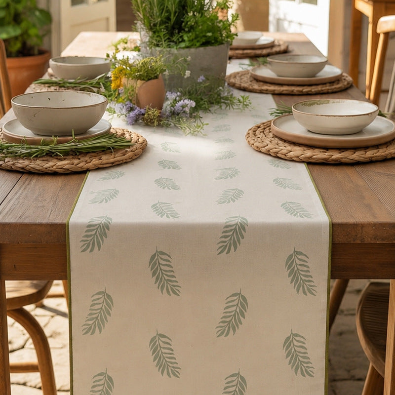 Woven table runner in botanical leaf pattern made of cotton blend Stornfield