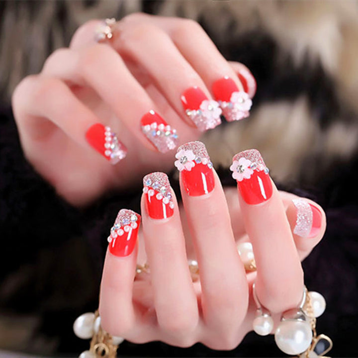 Artificials nails with sparkling rhinestone accents and elegant flower embellishments Stornfield