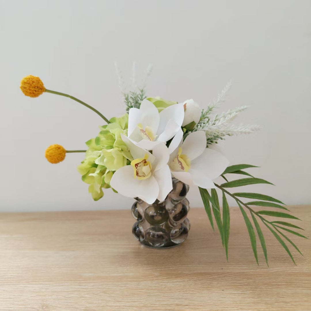 Lifelike Floral Arrangement with Orchids and Greenery