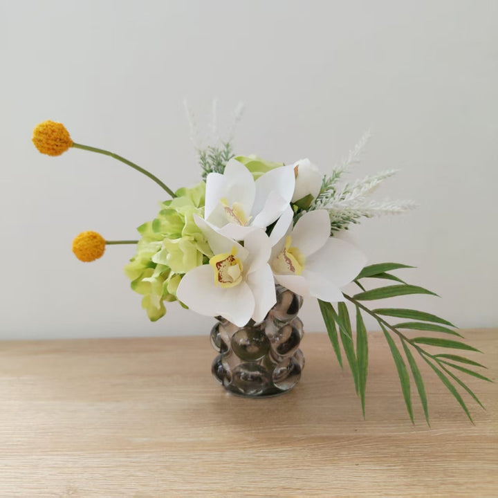 Lifelike Floral Arrangement with Orchids and Greenery