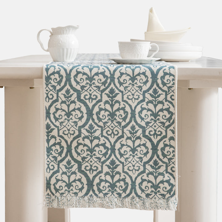 Woven table runner with flower jacquard, fringes and cotton blend