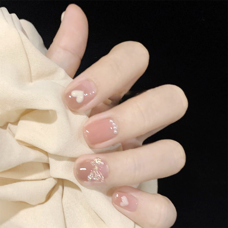 Artificial nails with romantic hearts and glitter accents Stornfield