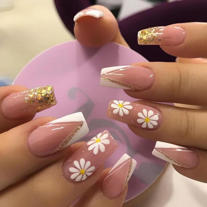 Artful nail extensions with floral designs and glitter accents Stornfield
