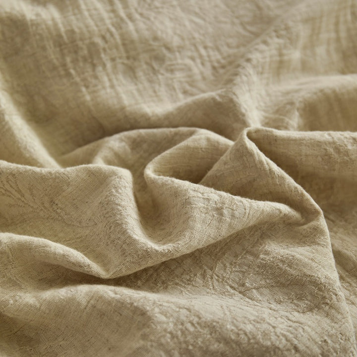 Quilted reversible bed with floral muslin surface and plush fleece back