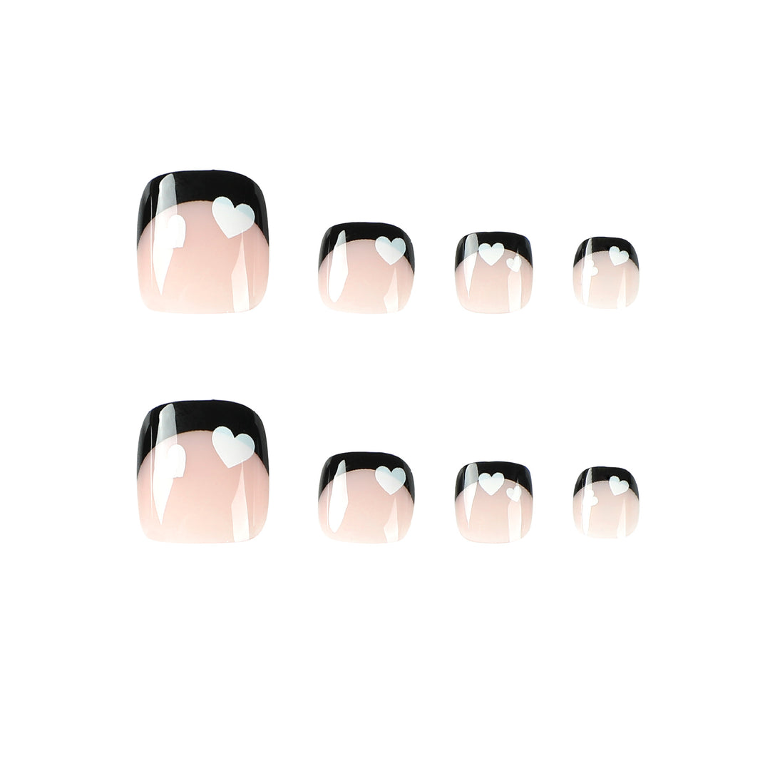 Artistic toenail design with heart motifs and modern black-and-white design Stornfield