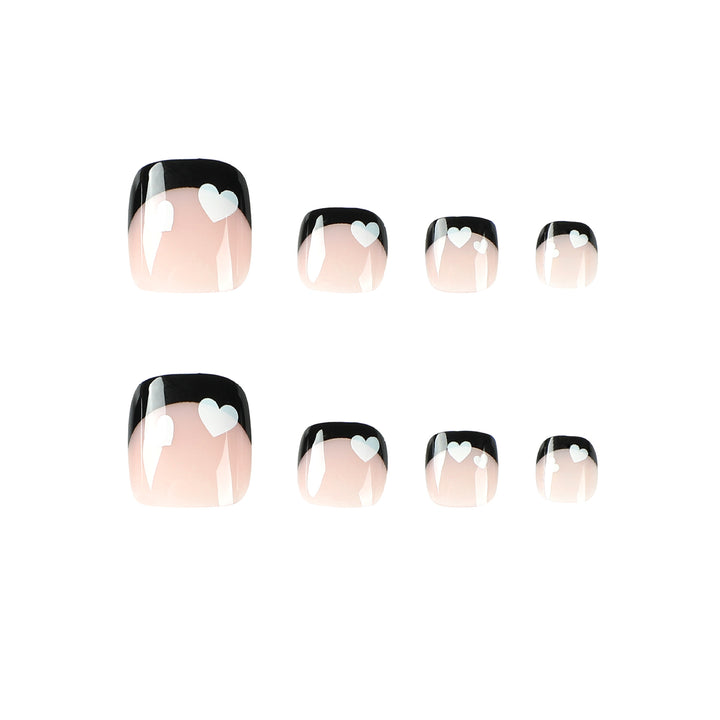 Artistic toenail design with heart motifs and modern black-and-white design Stornfield