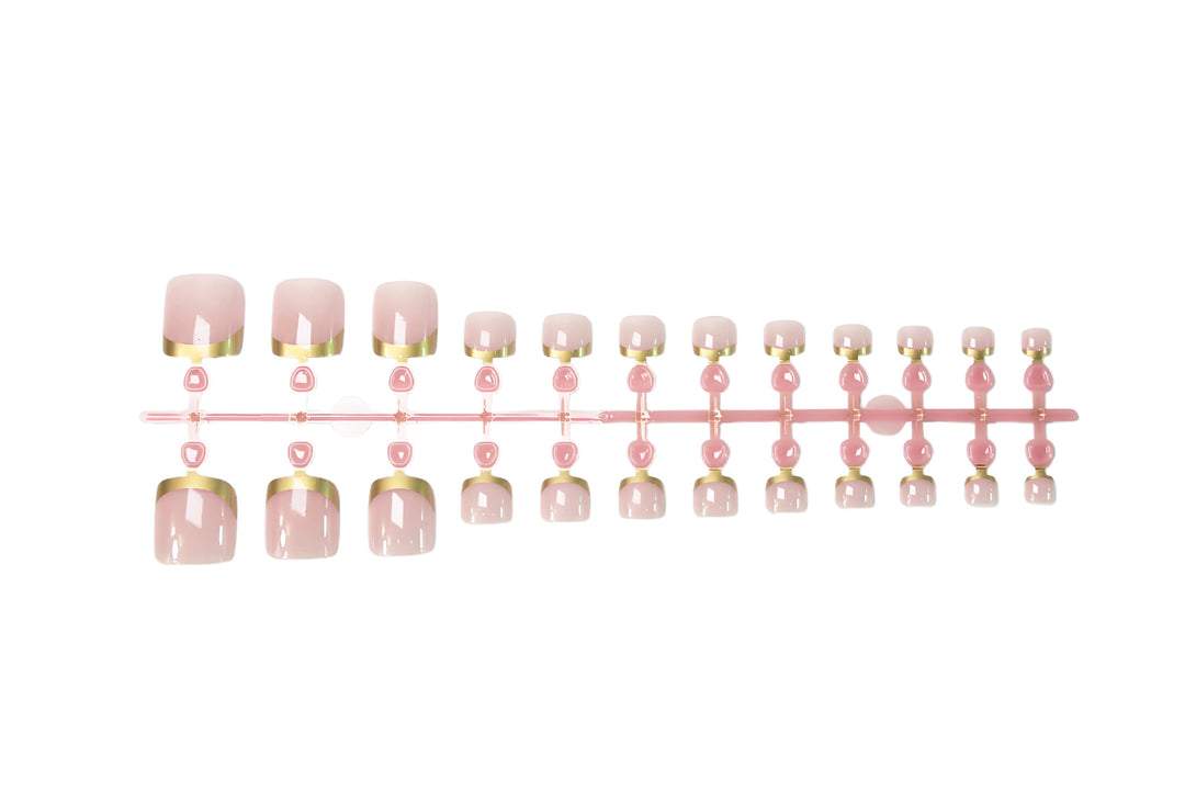 Toenail art set with elegant gold tips and delicate embellishments Stornfield