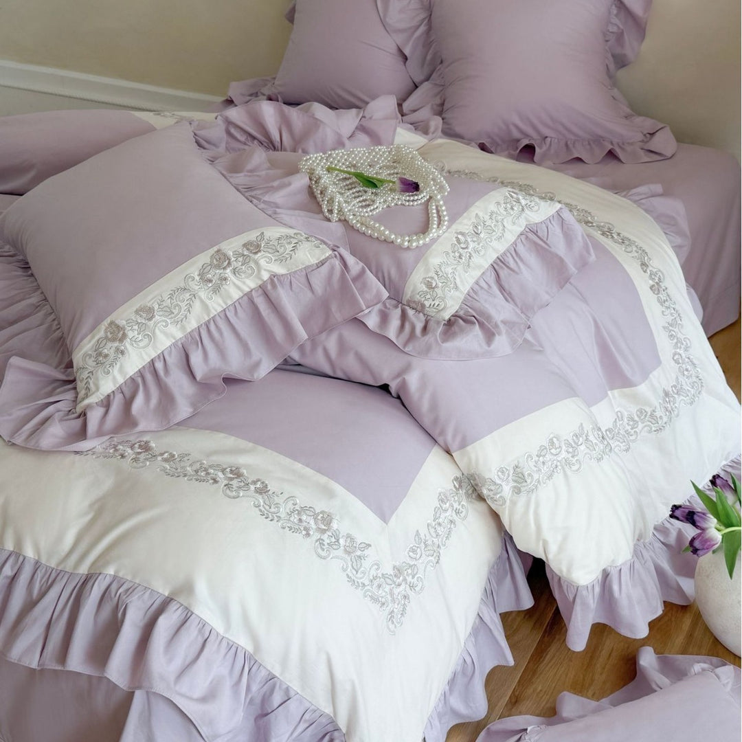 Designer bed linen set with ruffle hem and fine border embroidery