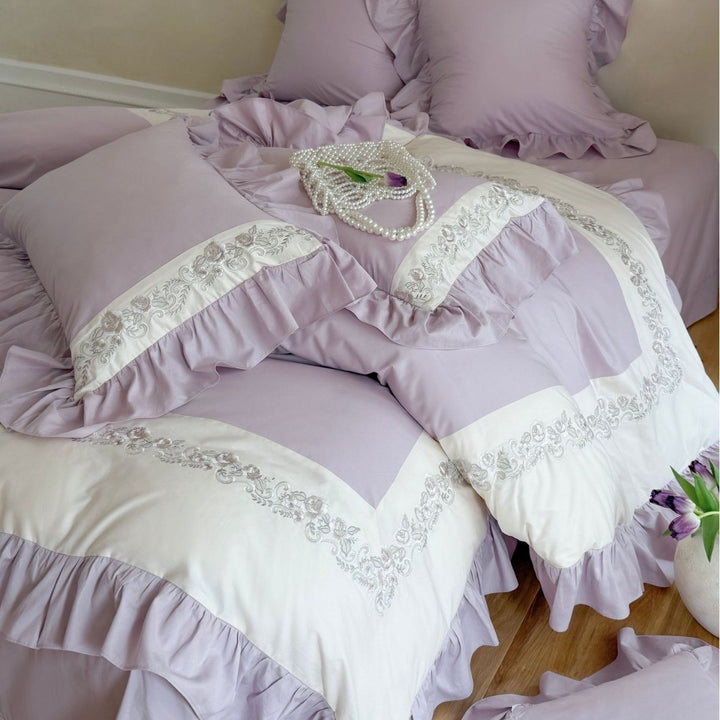 Designer bed linen set with ruffle hem and fine border embroidery